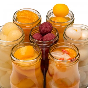 Canned fruit mixed with canned yellow peach in syrup canned lychee, loquat and orange